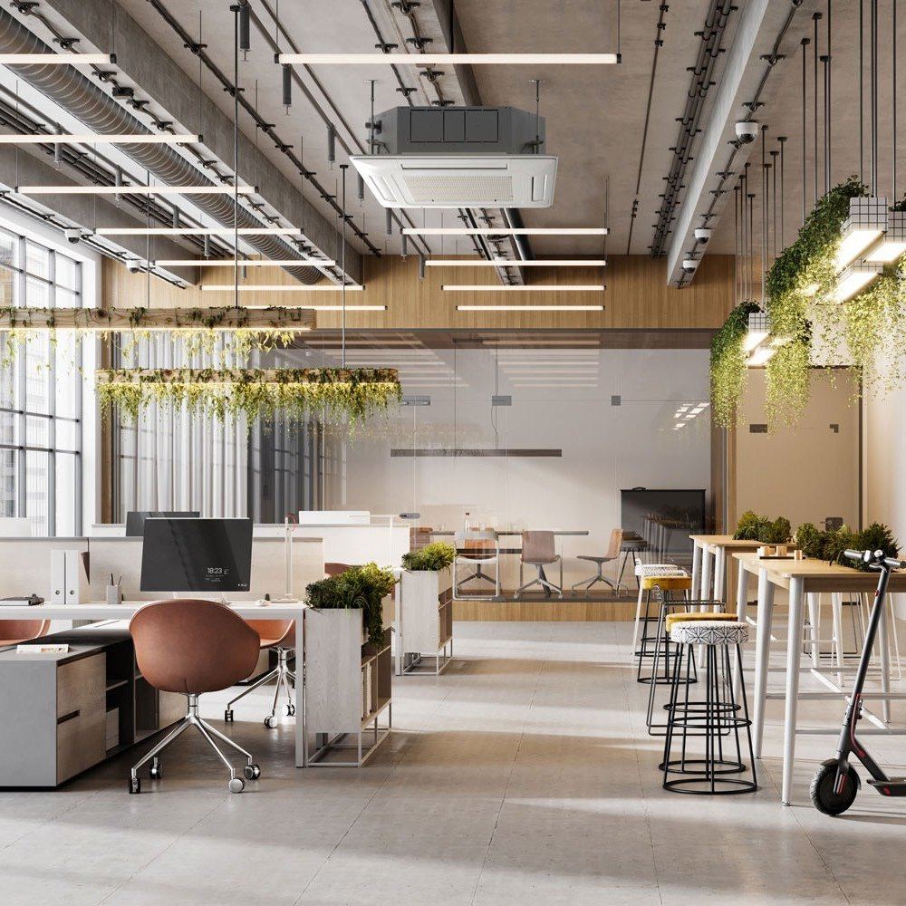 An open plan office with a four-way ceiling cassette and a concealed ducted unit both visible in the exposed ceiling above the desks